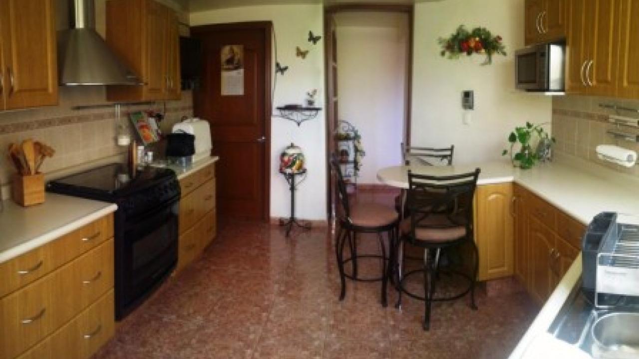 Cocina equipada con acceso desde comedor y salida a jardin y cuarto de servicio